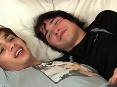 Two perfect twinks nuzzle passionately in bed